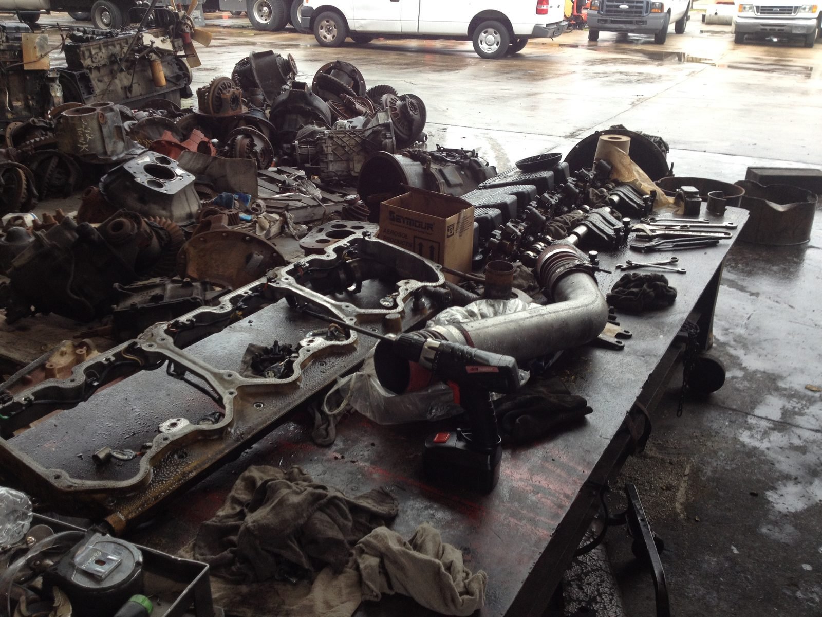 The failed Caterpillar C15 parts on the bench after the crankshaft and a connecting rod broke