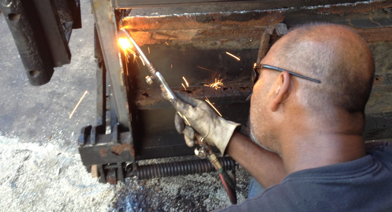 Cutting away rusted steel before framing the platform with new steel