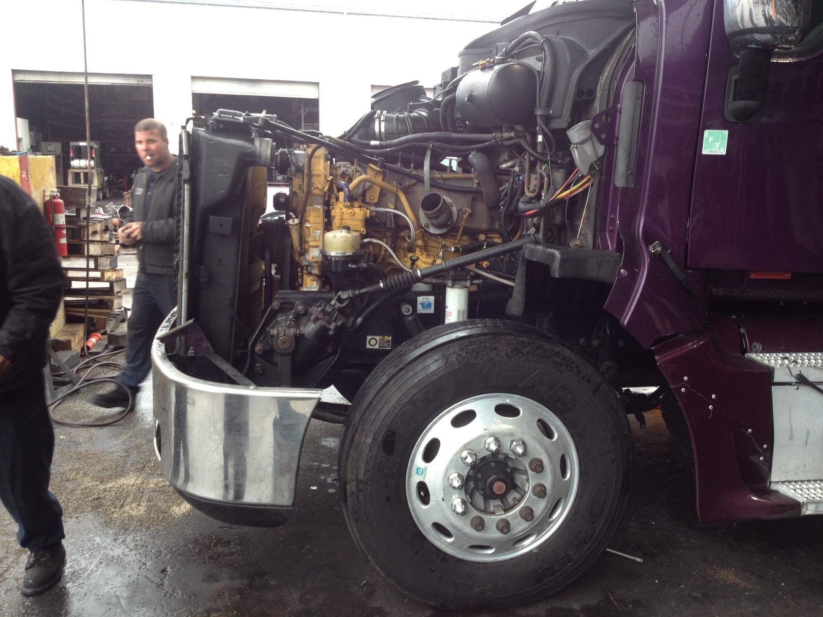 A Peterbilt in the shop with its replacement Caterpillar C15 installed